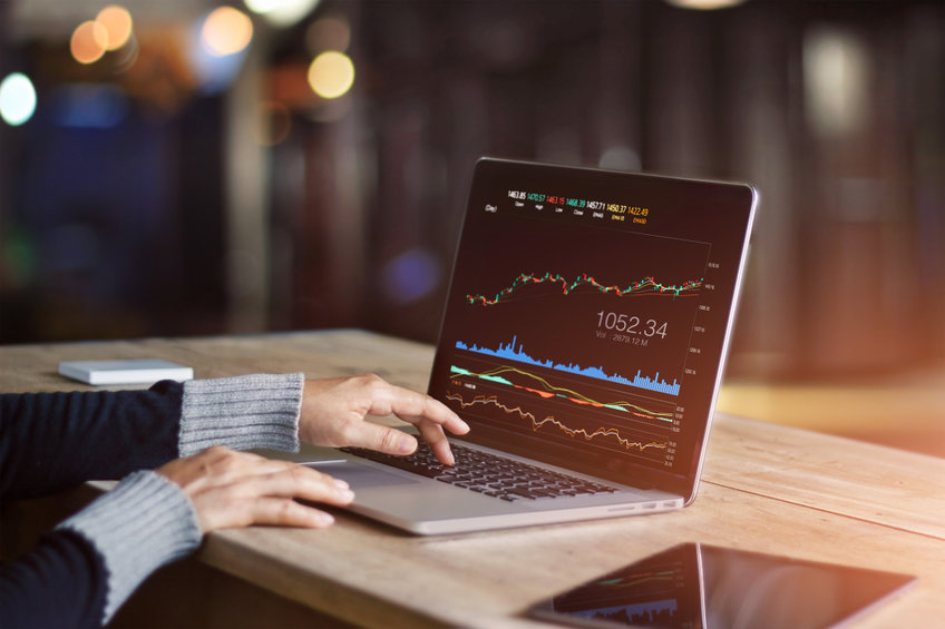 Businessman using laptop for analyzing data stock market, forex