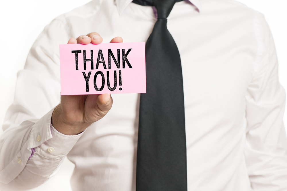 Man,Holding,Paper,With,Thank,You,Text,Isolated,Over,White